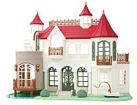 Vila s červenou střechou u řeky